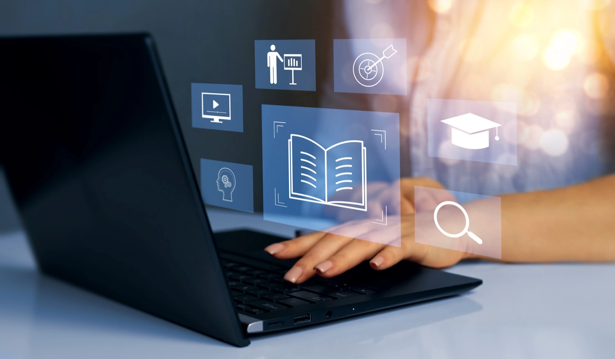 Graphic of a woman typing on a laptop with an overlay of icons showing education and training.